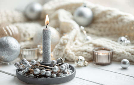 Cozy winter background with burning candle, copy space.の写真素材