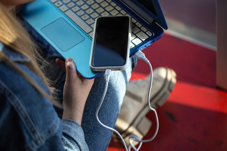 The smartphone is connected to the laptop via USB cable.