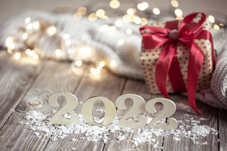 Cozy holiday composition with the numbers 2022 on a blurred background in bokeh.の写真素材