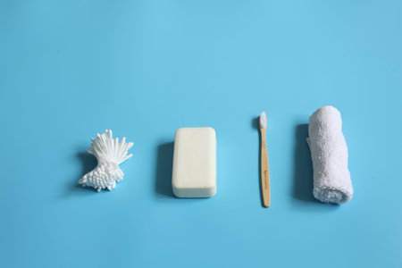 Spa composition with personal care products on a blue background, copy space.