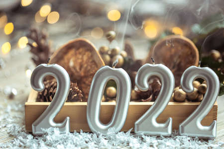 Festive New Year background with candles in the form of the numbers 2022.の写真素材