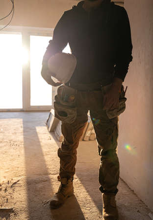 A man builder with a helmet in his hands.の写真素材