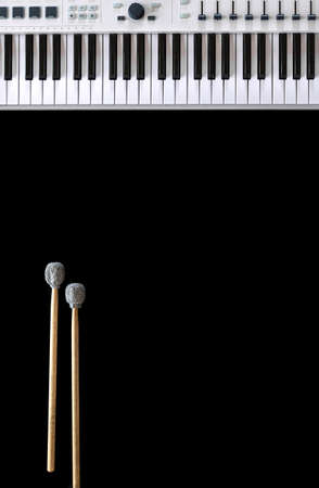 Musical background with musical keys and drum sticks top view.の写真素材