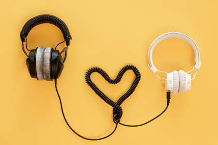 Flat lay musical background with black and white headphones.の写真素材