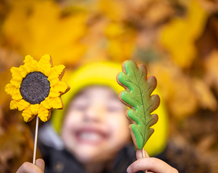 Bright autumn gingerbread in the hands of a child.の写真素材