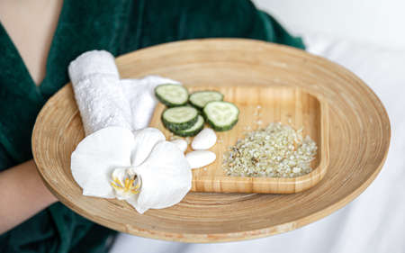 Spa composition with wooden plate with cucumber slices and sea salt.の写真素材