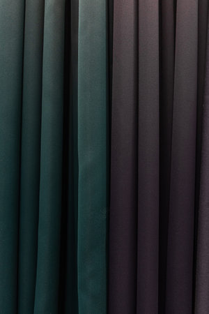 Set of dark multi-colored dense fabrics of uniform texture.