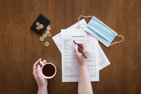 Visa application form on a wooden table, visa processing, registration, flat layの写真素材
