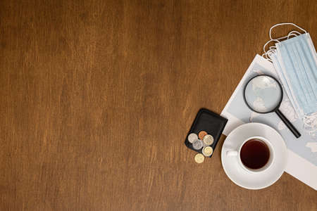 Flat lay travel composition with world map on wooden background.の写真素材