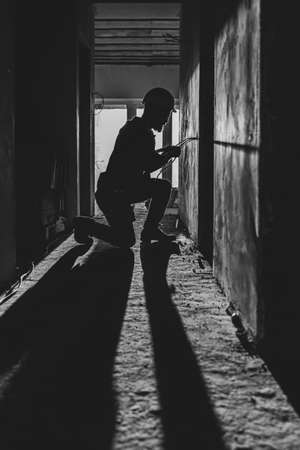 Worker is cutting wires with linemans pliers.の写真素材