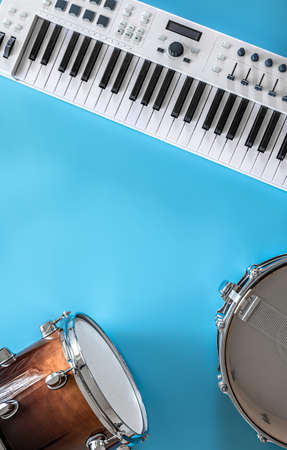 Musical keys and drums on a blue background, flat lay, copy space.の写真素材