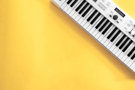 Musical background with musical keys on yellow, flat lay, copy space.の写真素材