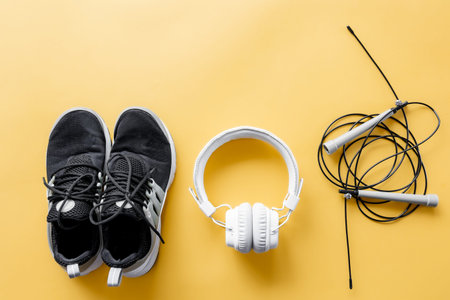 Flat lay composition with sports equipment on yellow background.