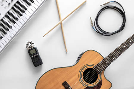 Acoustic guitar and musical keys on a white background, flat lay.の写真素材