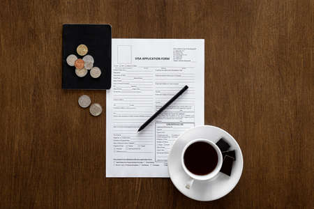Visa application form on a wooden table, visa processing, registration, flat layの写真素材