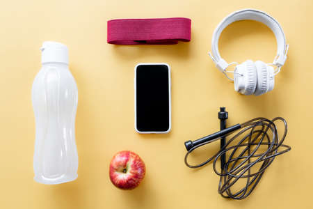 Flat lay composition with sports equipment on yellow background.の写真素材