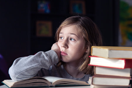 Portrait of a little girl with a book, a child reads a book.