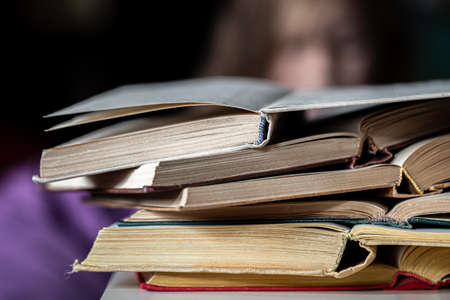 Close-up of a stack of open books on a blurred background.の写真素材