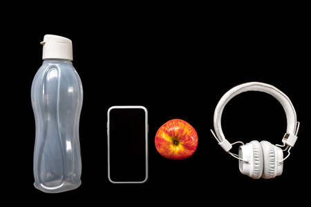 Flat lay composition with sports equipment on black.