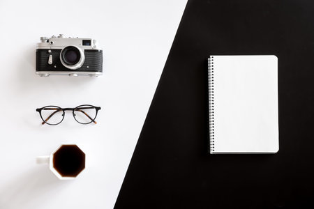 Vintage camera, coffee cup, glasses and notepad, flat lay.の写真素材