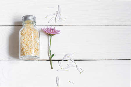 Jar with sea salt on a white wooden background.の写真素材