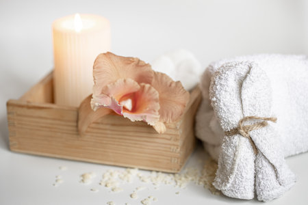 Spa composition with body care products in a wooden box and Thai orchid flowers.の写真素材