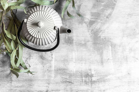 Beautiful ceramic teapot on a concrete background, top view, copy space.の写真素材