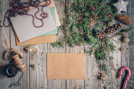 Flat lay Christmas composition with letters on a wooden surface.