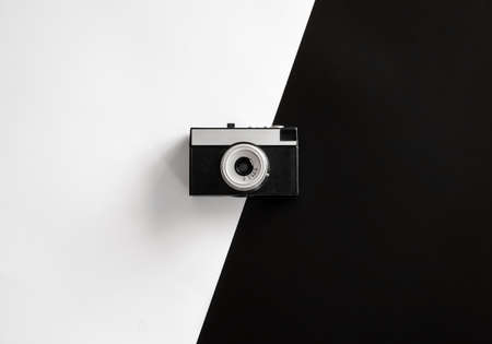 Vintage retro camera on black and white background, flat lay.の写真素材