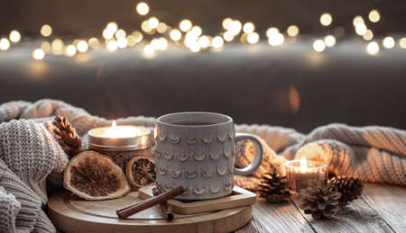 Beautiful christmas cup and candles on blurred background with bokeh.の写真素材