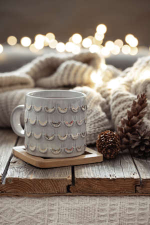 Beautiful christmas cup and candles on blurred background with bokeh.の写真素材