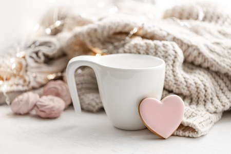 Composition for Valentines Day with a cup and a heart-shaped gingerbread.の写真素材