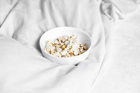 Close-up of a plate of popcorn in bed in the morning.の写真素材