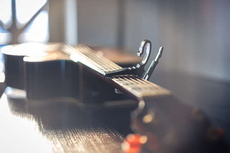 Close-up of an acoustic guitar on a blurred background.の写真素材