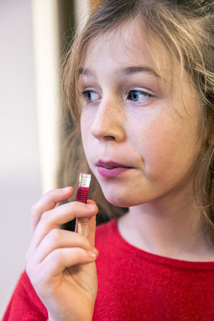 Close up, little girl eating gummy candy.の写真素材