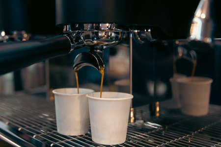 The process of preparing espresso in a professional coffee machine, close-up.の写真素材