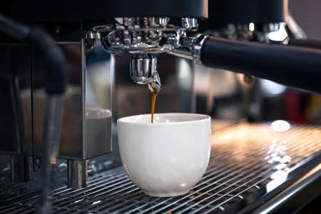 The process of preparing espresso in a professional coffee machine, close-up.の写真素材