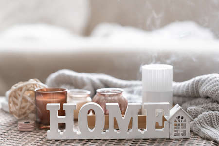 Close up decorative word home on blurred background with candles.の写真素材