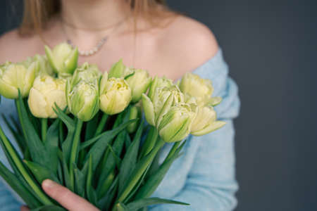 Close-up, a bouquet of tulips in female hands.の写真素材