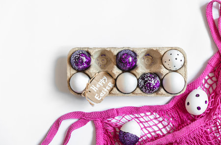 Easter background with decorative eggs tray isolated on white, flat lay.