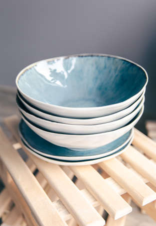 A set of beautiful plates in pastel colors on a gray background.の写真素材