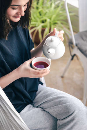 Portrait of a young woman with a cup of tea in a cafe.の写真素材