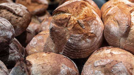 Large loaves of bread on the counter of a bakery.の写真素材
