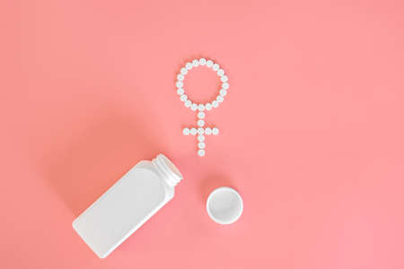 Pills on a pink background, flat lay, womens health.の写真素材
