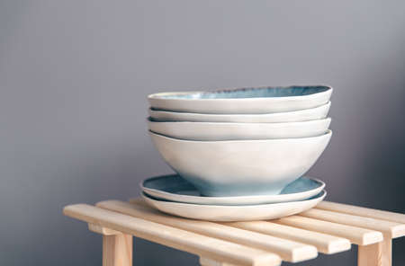 A set of beautiful plates in pastel colors on a gray background.の写真素材