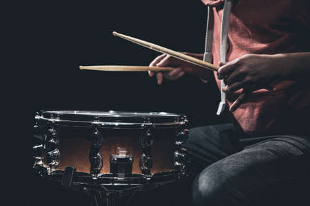 The drummers hands hold drumsticks and play the snare drum.の写真素材