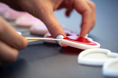 Close-up, the process of making heart-shaped lollipops.の写真素材
