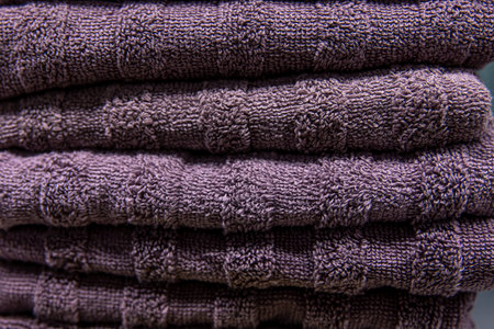 Textured violet bath towels stacked close up.の写真素材