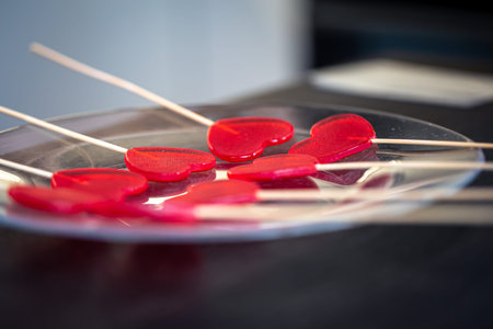 Close-up, the process of making heart-shaped lollipops.