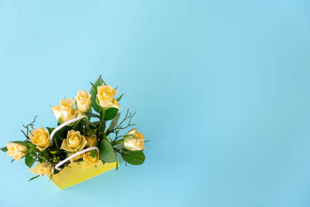 Bouquet of yellow flowers on a blue background, flat lay.の写真素材